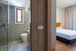 a bathroom with a bed a toilet and a shower at STAY Cityscape Charm in Nicosia