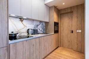 a kitchen with wood paneling and a counter top at STAY Cityscape Charm in Nicosia