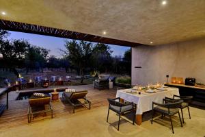 a patio with a table and chairs and a fireplace at Ngala Lodge in Klipdrift