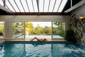 una persona en el borde de una piscina en Hotel Jardins da Colina en Nova Petrópolis