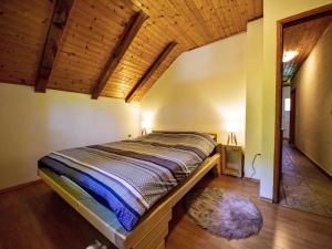 a bed in a room with a wooden ceiling at Kuća za odmor Ravno in Bribir +22 photos