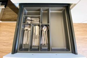 a black tray with utensils in it at 230 Lux Furnished flat in Beaufort