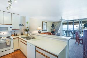 a kitchen with a sink and a counter top at "Picturesque Oceanfront" Wailua Bay View Condo with an Coastline View in Kapaa