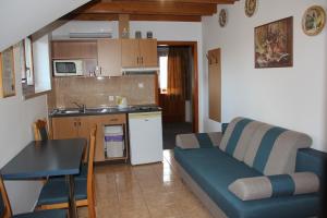 a living room with a couch and a kitchen at Laura Villa in Veľký Meder