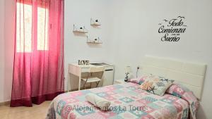 1 dormitorio con cama y escritorio. en Nice Home Family - Alojamientos La Torre, en Torre del Mar