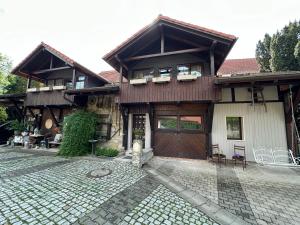 a house with a stone driveway in front of it at BIO Kastanienhof Erfurt - Appartements und ayurvedische Jurten in Erfurt +162 photos