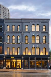 a large blue building with many windows at Kinn Guesthouse Downtown in Milwaukee