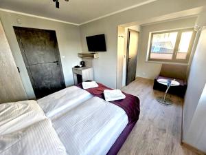 a hotel room with a bed and a window at Pokoje Dziwnów Welle in Dziwnów +57 photos