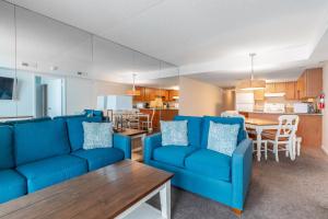 a living room with a blue couch and a table at Bay Club Resort in Ocean City