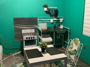 a toy kitchen with a stove and a table at Hospederia Villa Alegre Estudio 7 in Cabo Rojo