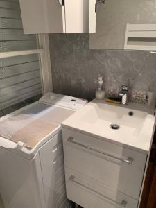 a kitchen with a white sink and a counter at 2 pièces La Clusaz Centre village dans petite résidence in La Clusaz