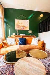 a living room with a couch and two tables at The Good Vibes Honfleur & pkg included in Honfleur