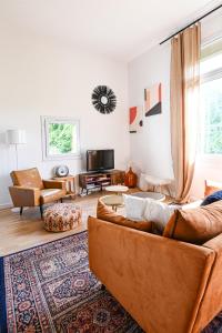 a living room with two couches and a tv at The Good Vibes Honfleur & pkg included in Honfleur