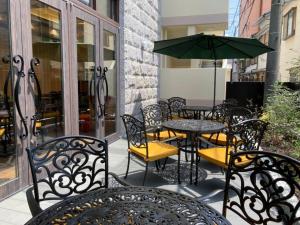 a patio with tables and chairs and an umbrella at FIVE HOTEL OSAKA - Vacation STAY 47127v in Osaka