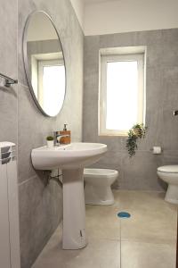 a bathroom with a sink and a mirror at Casa Benesere Corpo E Mente in Castel Volturno