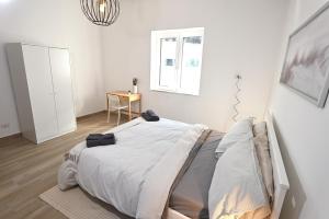 a white bedroom with a large bed in it at Casa Benesere Corpo E Mente in Castel Volturno