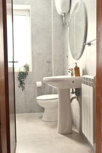 a bathroom with a sink and a mirror and a toilet at Casa Benesere Corpo E Mente in Castel Volturno +12 photos