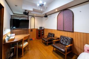 a room with a table and chairs and a tv at Grand Hotel Narita Airport - Vacation STAY 56458v in Narita