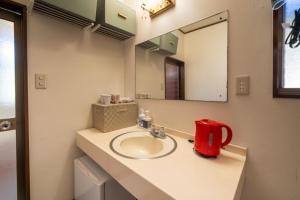 a bathroom with a sink and a red appliance at Grand Hotel Narita Airport - Vacation STAY 56458v in Narita
