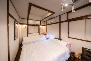 two beds in a room with white sheets at Grand Hotel Narita Airport - Vacation STAY 56506v in Narita