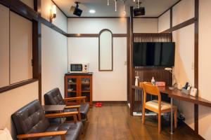 a living room with chairs and a table and a television at Grand Hotel Narita Airport - Vacation STAY 56520v in Narita
