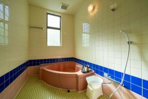a bathroom with a tub and a toilet and a sink at Grand Hotel Narita Airport - Vacation STAY 56520v in Narita +7 photos