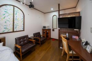 a hotel room with a bed and a desk and chairs at Grand Hotel Narita Airport - Vacation STAY 56501v in Narita