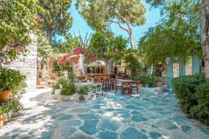 a patio with tables and chairs and trees at Ha La Bodrum in Bodrum City
