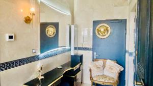 a bathroom with blue walls and a sink and a chair at Appartement La Suite Royale Centre Luxembourg 2 chambres in Luxembourg +20 photos