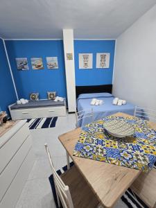 a dining room with a table and blue walls at Destinazione Mare Naxos in Giardini Naxos