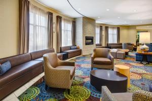 a hotel lobby with couches and chairs at Holiday Inn Canton-Belden Village, an IHG Hotel in Canton