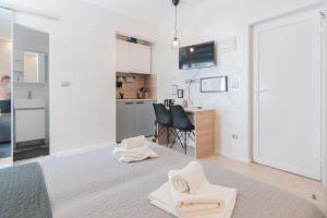 a white room with a bed and a kitchen at OLD TOWN PULA STUDIO APARTMENTS in Pula