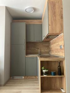 a small kitchen with a sink and a refrigerator at Cozy studio by the seaside in Byala