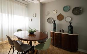 a dining room with a wooden table and chairs at Sunny 4 Bedroom Apartment - with View in Coimbra