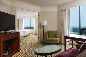 um quarto de hotel com uma cama e uma televisão em Washington Dulles Marriott Suites em Herndon