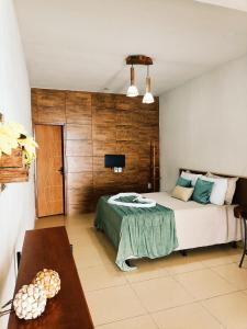 Ένα ή περισσότερα κρεβάτια σε δωμάτιο στο Pousada Villa Coqueirais