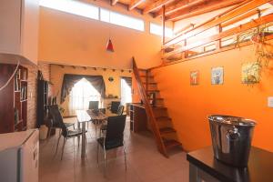 a room with a table and chairs and a staircase at Depto con estacionamiento privado en Malargüe in Malargüe +9 photos