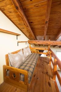a bed in a room with a wooden ceiling at Depto con estacionamiento privado en Malargüe in Malargüe