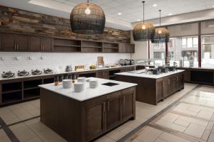 a large kitchen with brown cabinets and a kitchen island at Residence Inn Portland Downtown/RiverPlace in Portland