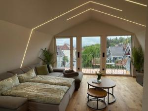 a living room with a couch and a table at Penthouse Alpenblick in Kempten