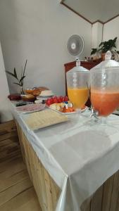 two vases filled with drinks on a table at Pousada Ponta da Baleia in Barra Grande
