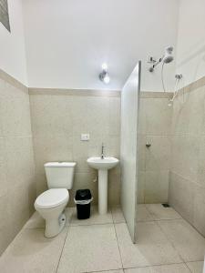 a bathroom with a toilet and a sink at Surfside Suites in Peruíbe