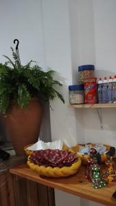 a table with a plate of food and a plant at Pousada Ponta da Baleia in Barra Grande