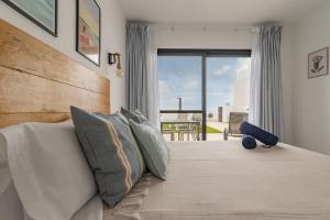 una camera con un letto e una grande finestra di Seascape Piscina climatizada aire acondicionado a Corralejo