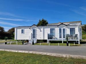 a white house on the side of a road at Lakes edge view in Millom