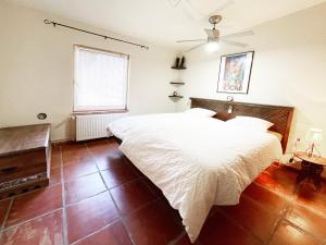 a bedroom with a large white bed and a window at Casa Mora, privater pool, Meerblick, toller Garten in Torrox +24 photos