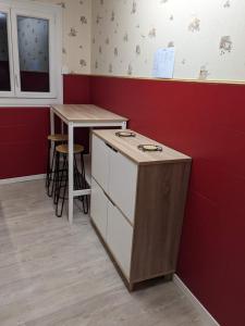 a small kitchen with a counter and a table at Au vieux pont romain in Amélie-les-Bains-Palalda