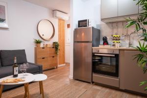 a kitchen with a stainless steel refrigerator and a table at Refugio en Albaicín y parking in Granada