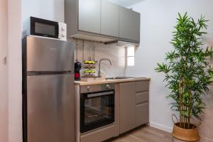 a kitchen with a stainless steel refrigerator and an oven at Refugio en Albaicín y parking in Granada +20 photos