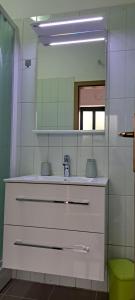 a bathroom with a sink and a mirror at Blanka Apartment in Orebić